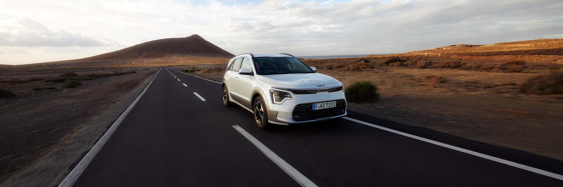 Kia Niro parked in mountains