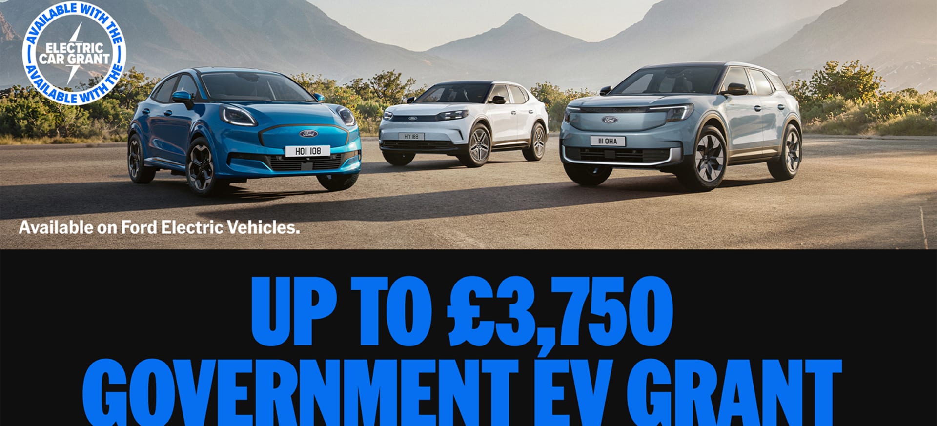 Three Ford electric vehicles parked on a road with mountains in the background.