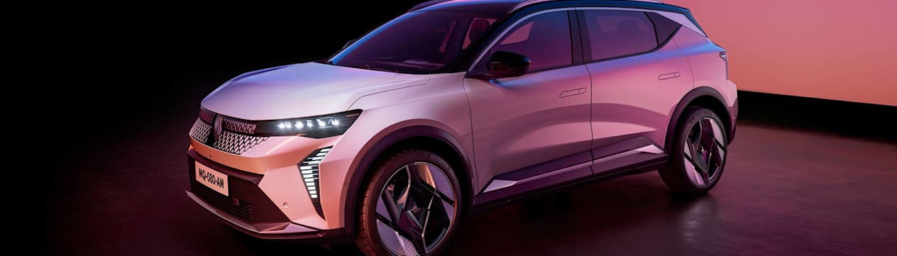Silver Scenie E-Tech lit with pink lighting in a studio. the 2024 Car of the Year badge is in the corner of the photo