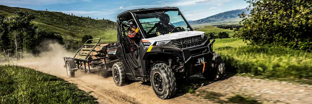 Polaris Ranger 1000 2023 : trois quarts avant sur chemin avec remorque