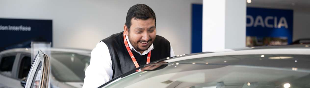 Wilsons Salesman showing customer a car