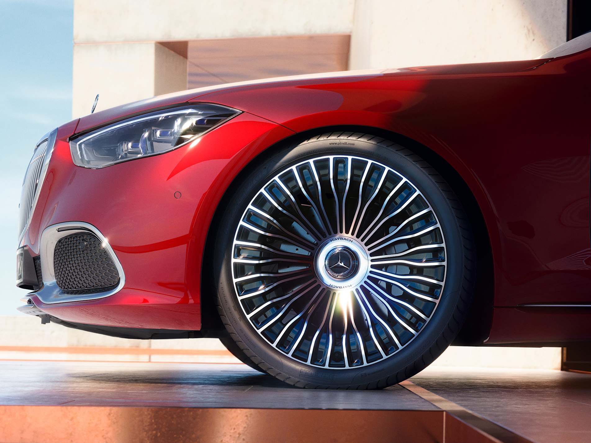 Close-up of a polished multi-spoke alloy wheel on a red Mercedes-Maybach S-Class