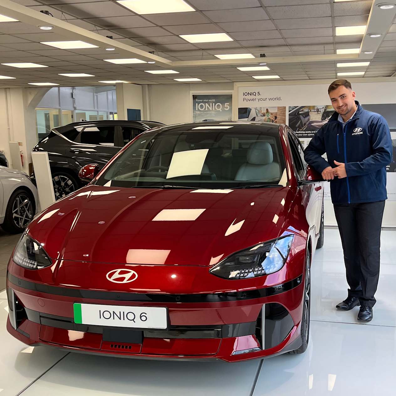 EV specialist next to IONIQ 6