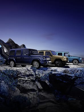 Mercedes-Benz G-Class SUVs on rocky terrain at dusk