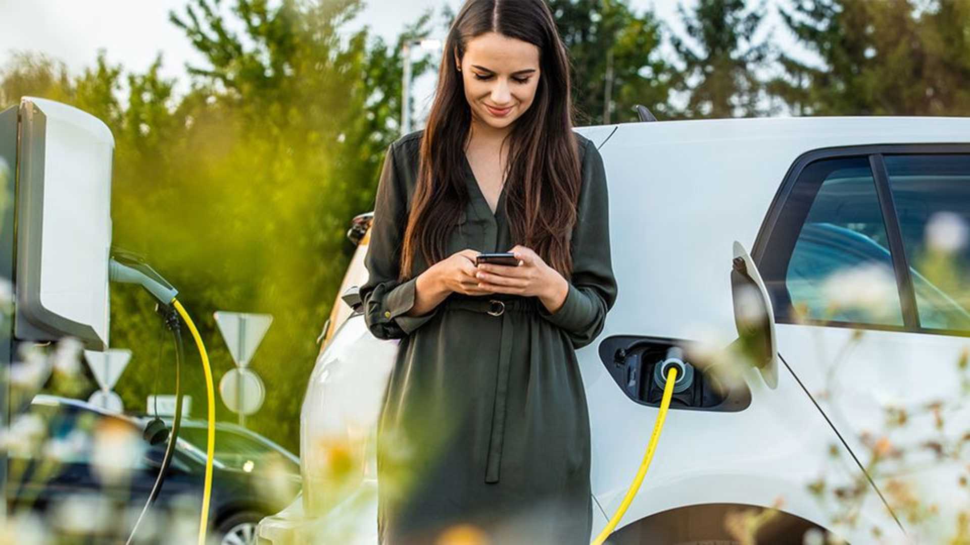 Women charging car in spring