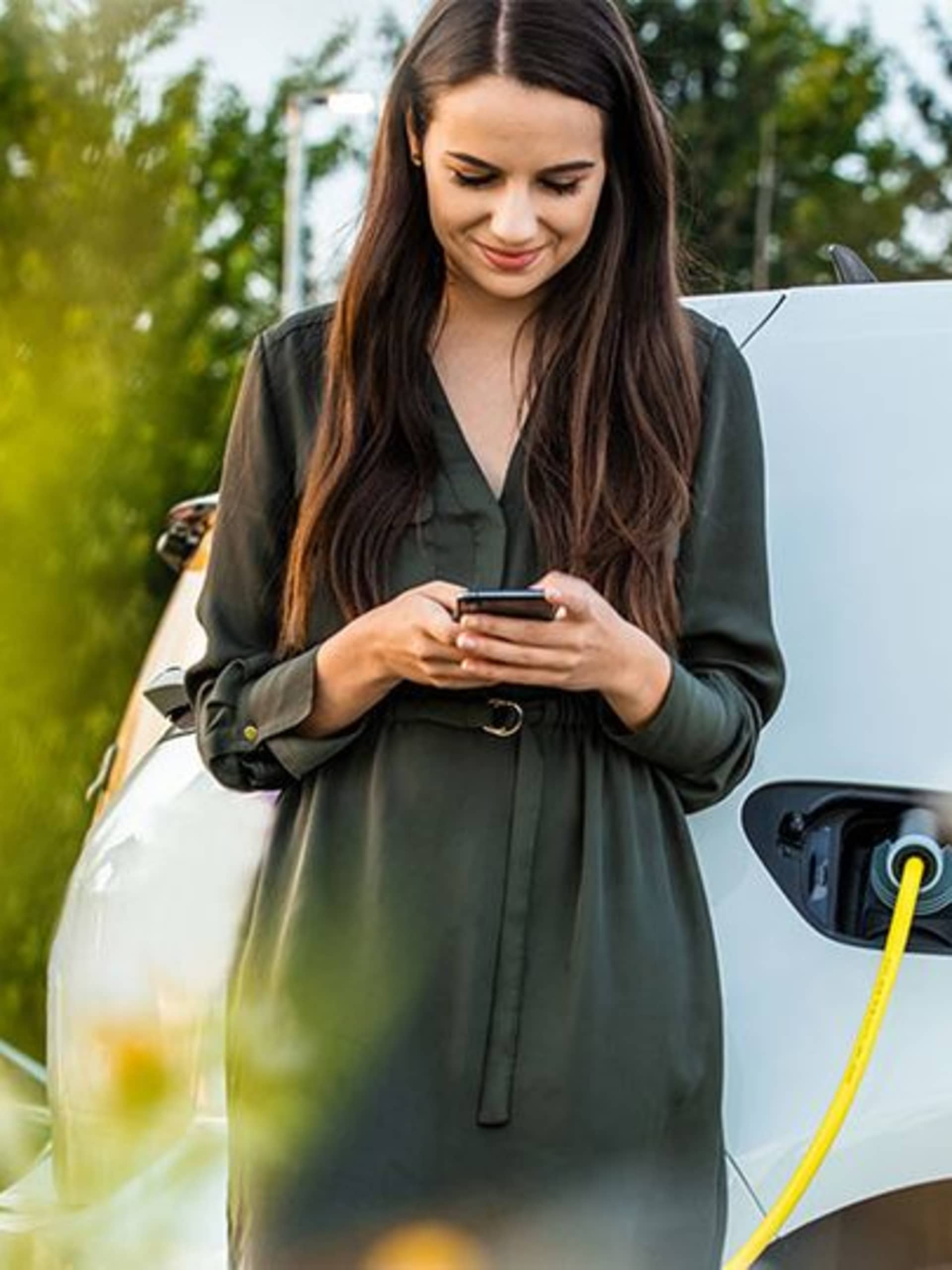 Women charging car in spring