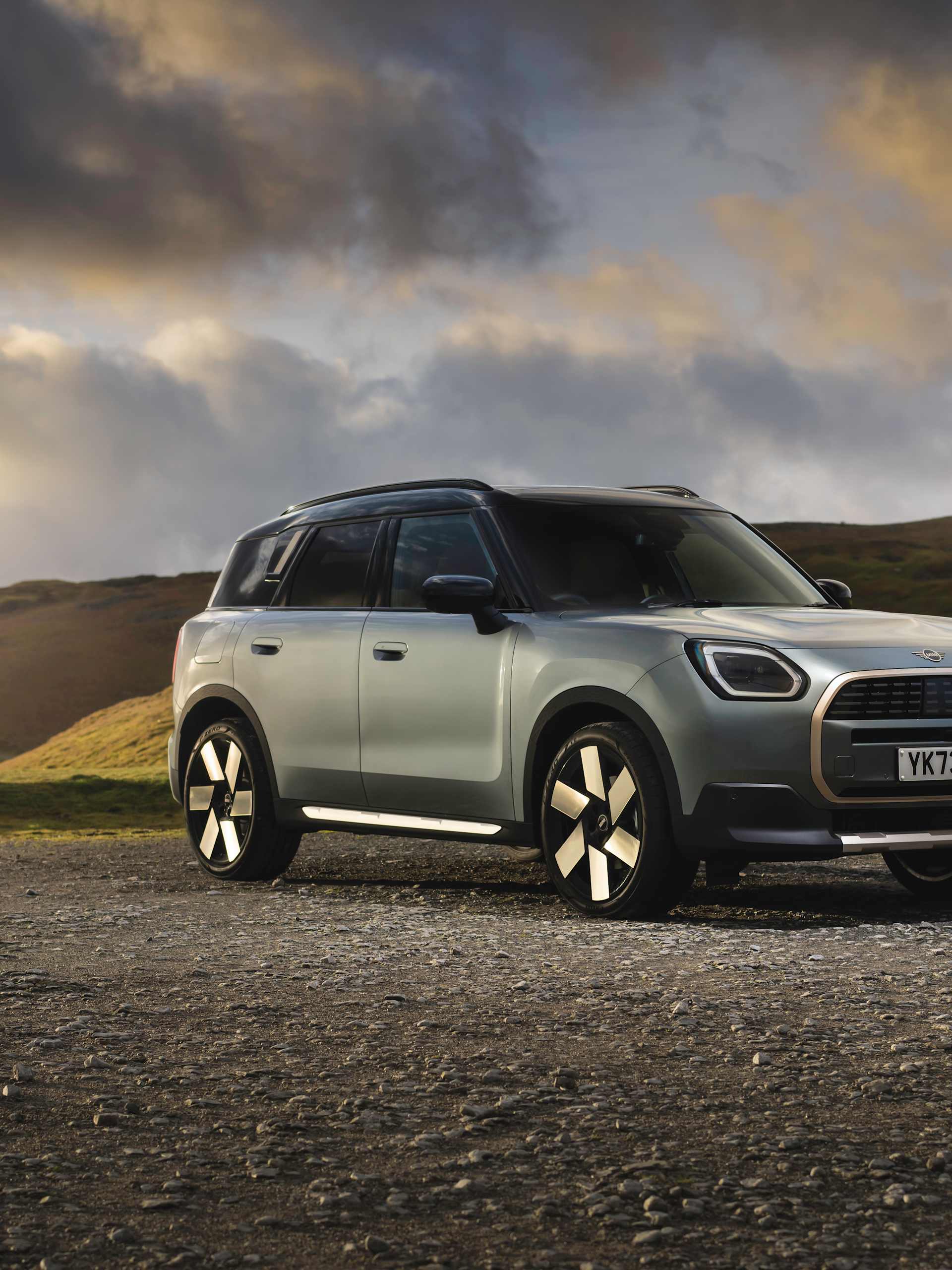The Electric MINI Countryman Pictured on a Mountain with a Sunset