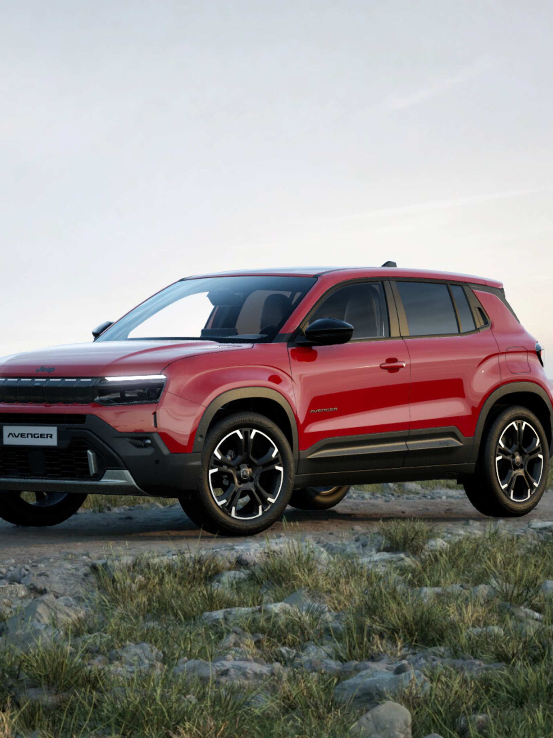 Jeep Avenger petrol Summit facing from the side on a mountain range