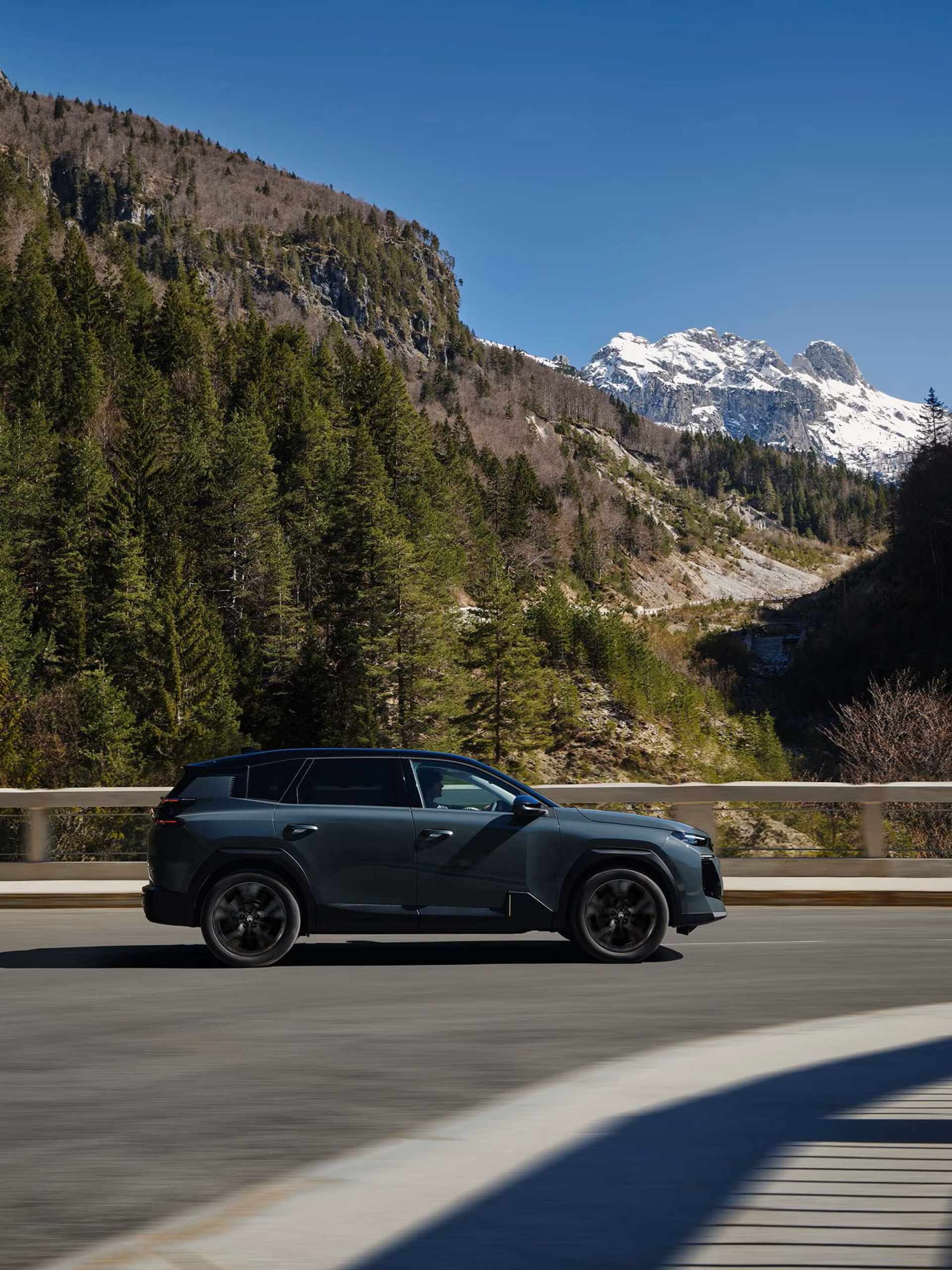 Citroen Aircross side profile driving along road with forest background