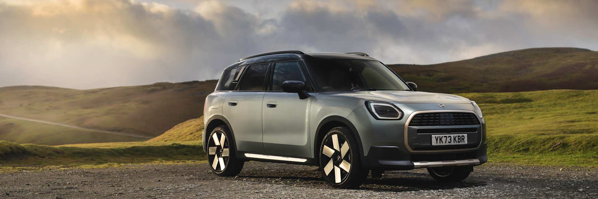 The Electric MINI Countryman Pictured on a Mountain with a Sunset