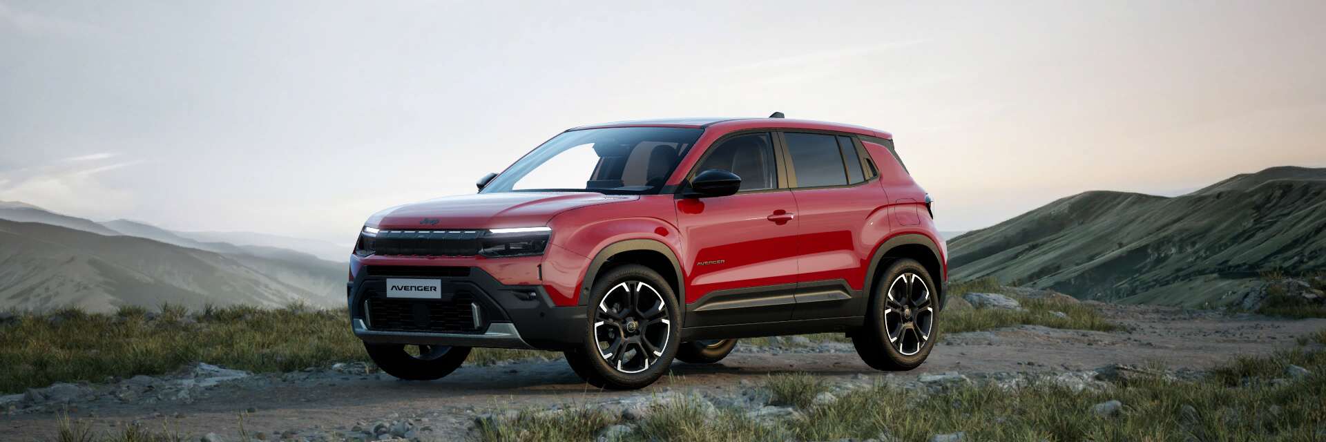 Jeep Avenger petrol Summit facing from the side on a mountain range