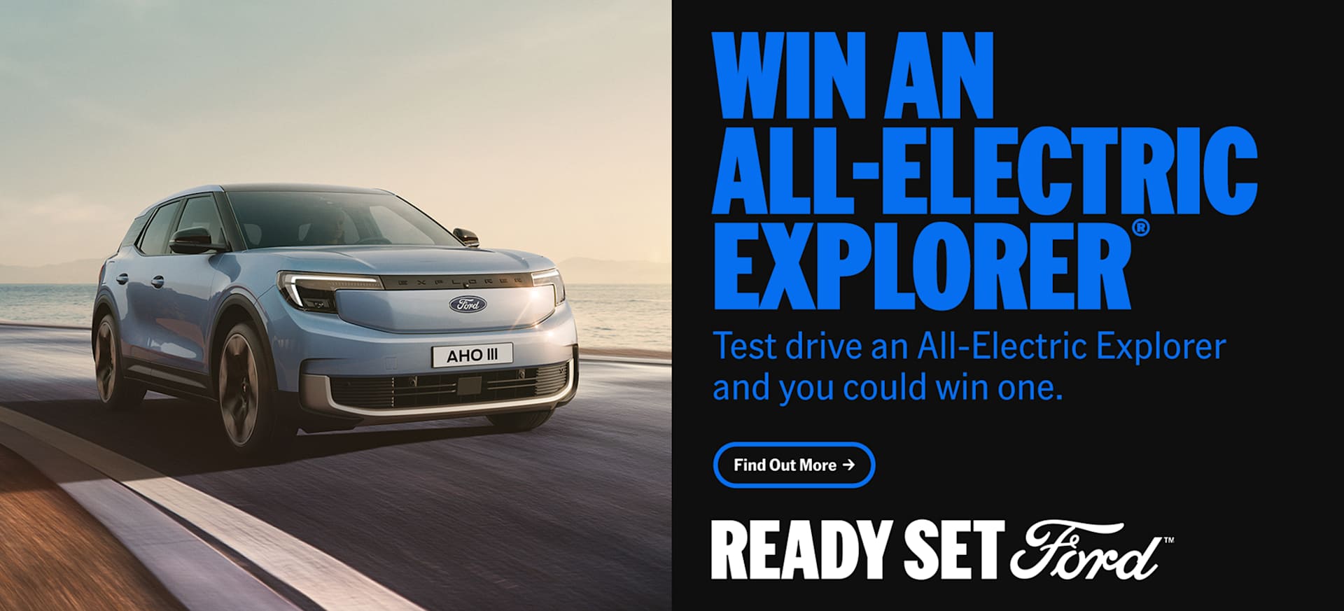 A blue all-electric Ford Explorer parked on a coastal road with a scenic background.