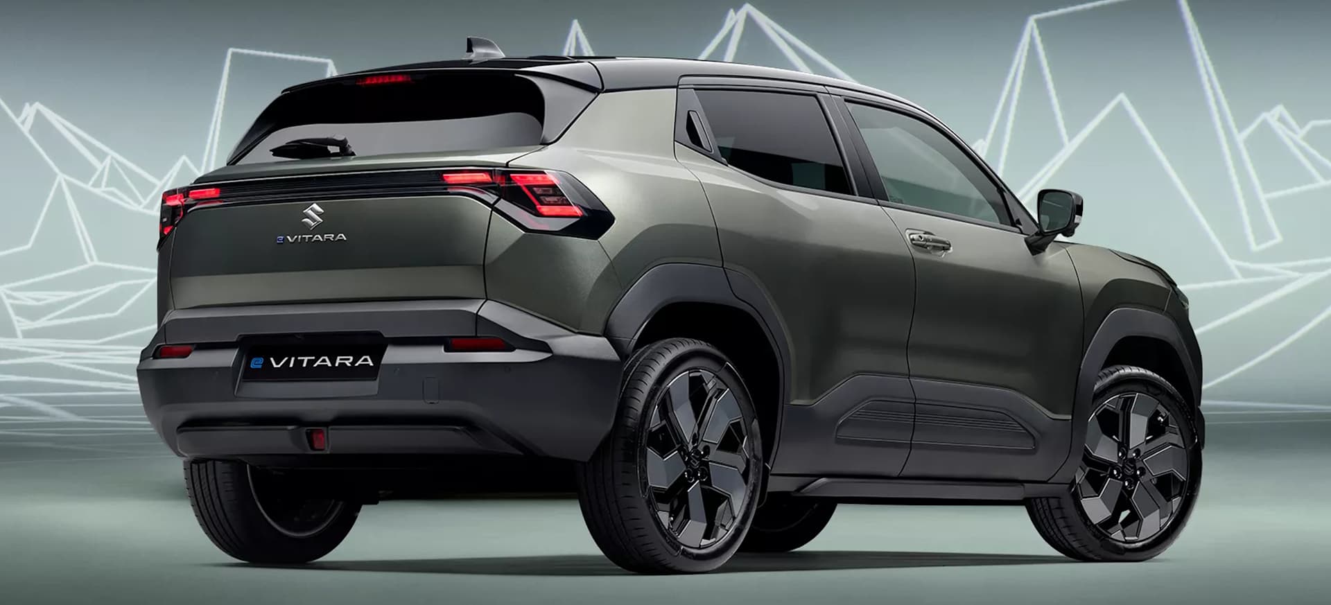 Rear of a Suzuki eVitara with it's sleek design, set against a geometric background of lines and shapes.