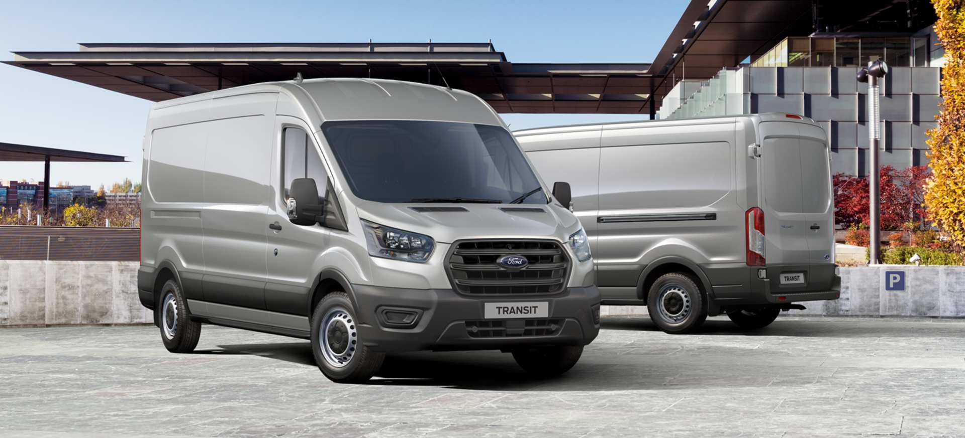 A silver Ford Transit van displayed from the front and rear in an urban setting.