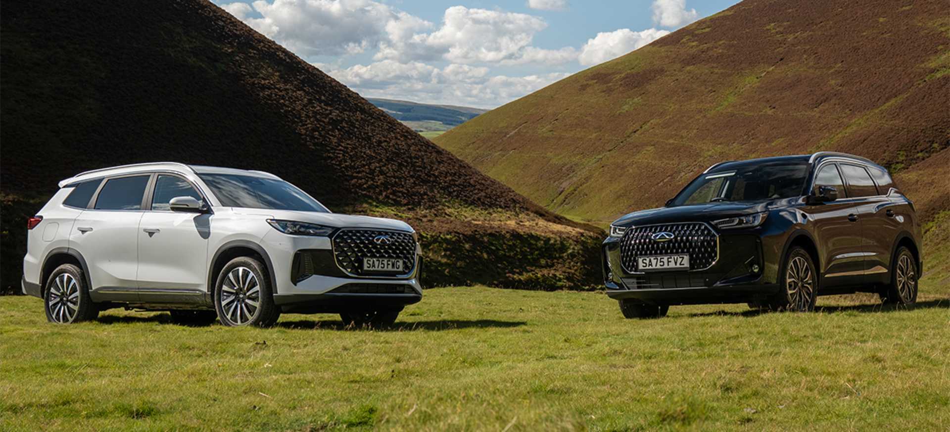 A Chery TIGGO 7 & TIGGO 8 parked on green grass between hills, under a partly cloudy sky.