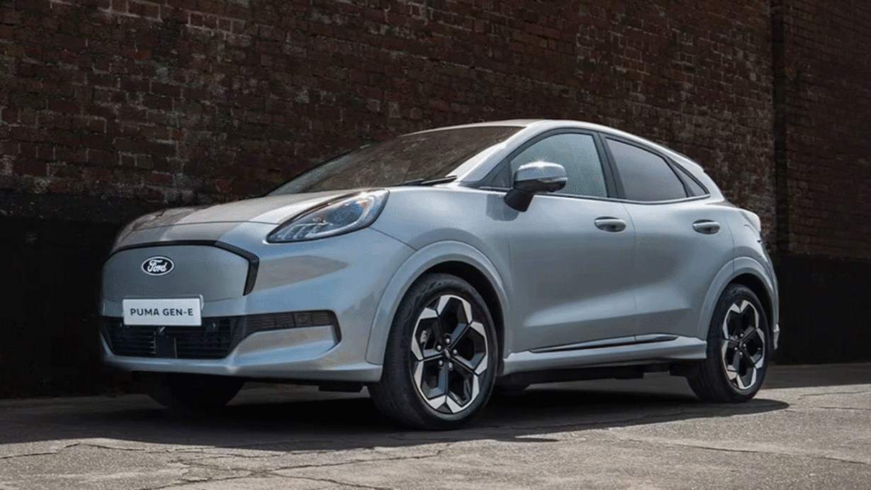 A silver Ford Puma Gen-E parked against a textured brick wall.