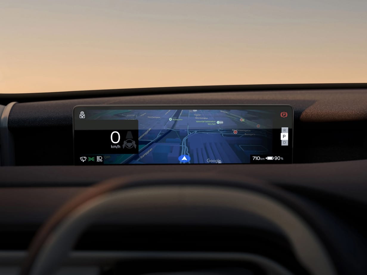 A Volvo EX60 dashboard displaying a digital speedometer and navigation map at sunset.