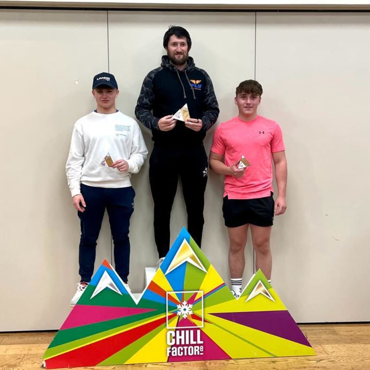 Grant Melville (In white jumper) on the podium