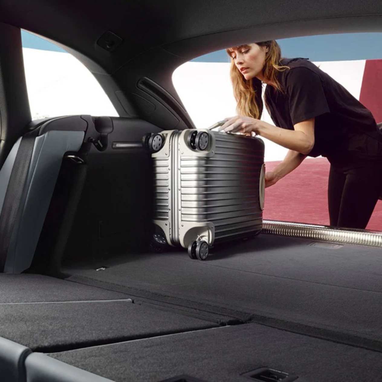 Woman putting luggage into the new Audi A4 Avant