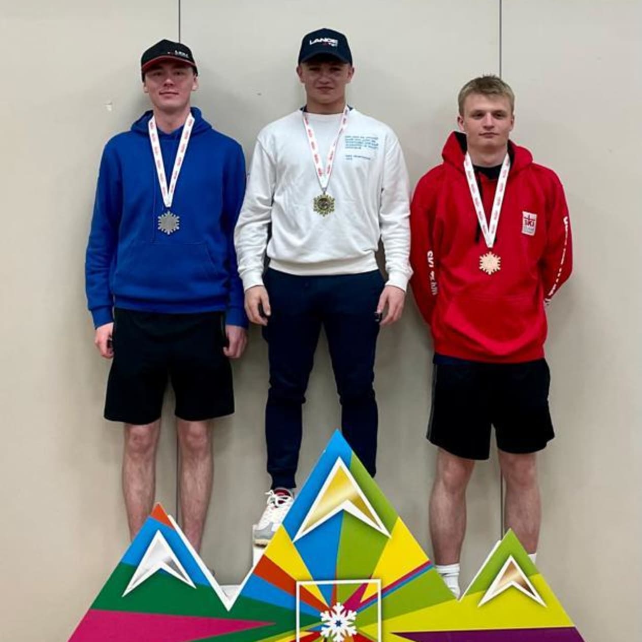 Grant Melville (In white jumper) on the podium