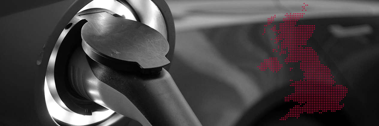 Close up of electric vehicle charging cable inserted into a car