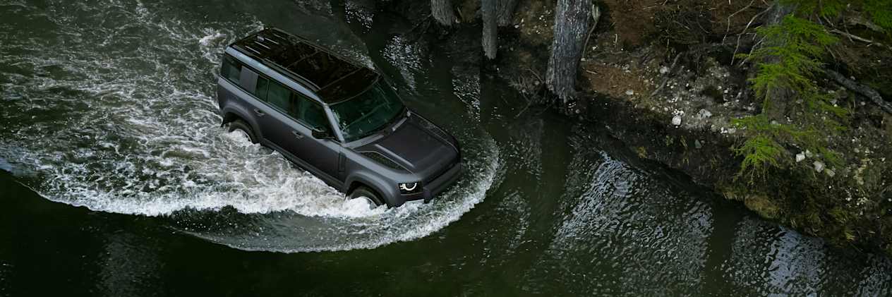 Defender 110 wading through water