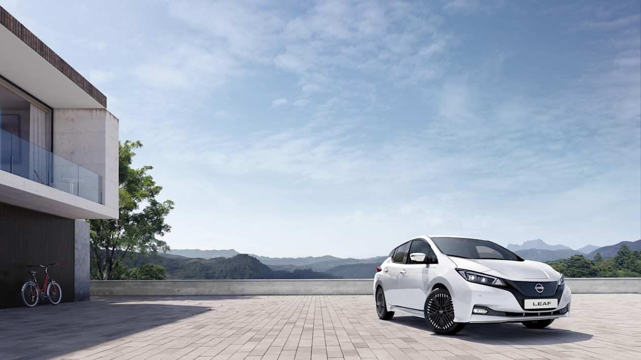 White Nissan LEAF Shiro sits in an open courtyard