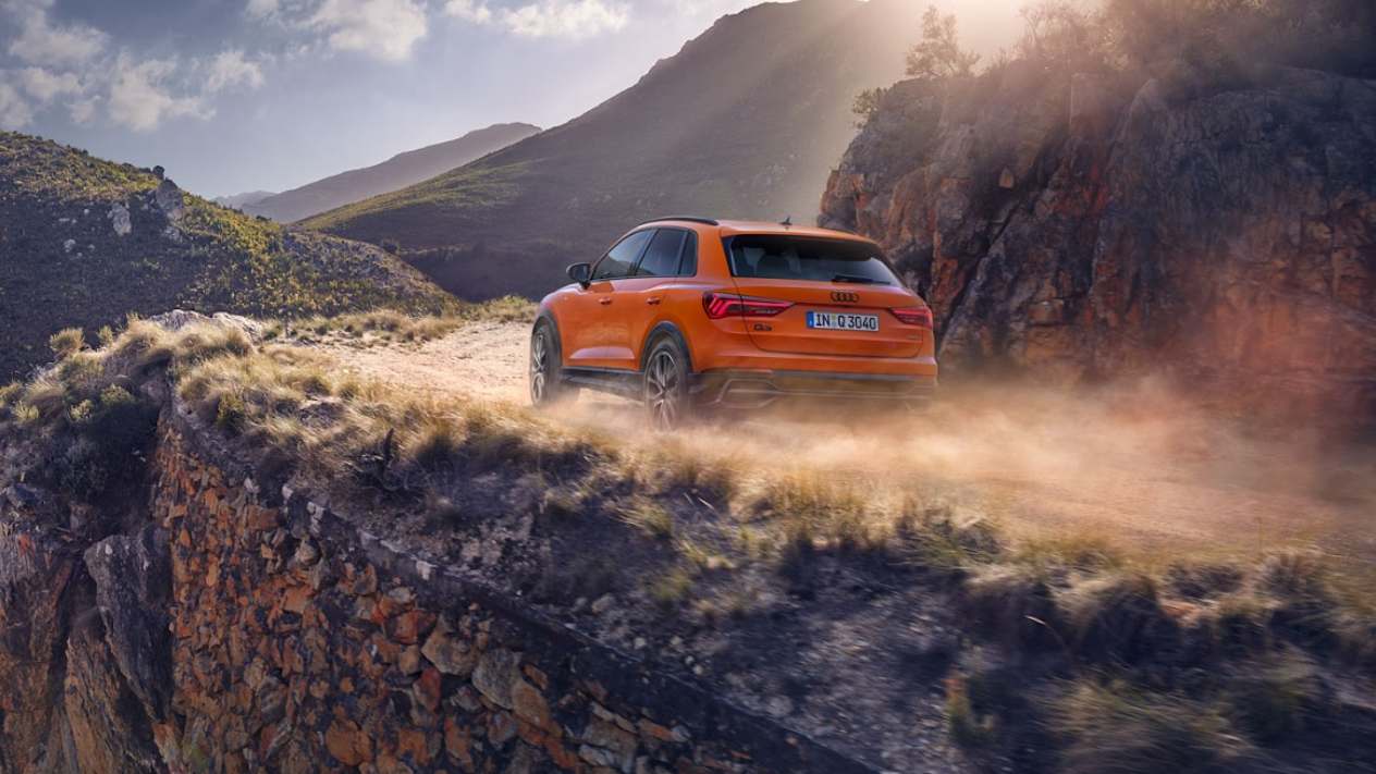 New Audi Q3 in Pulse Orange driving at height