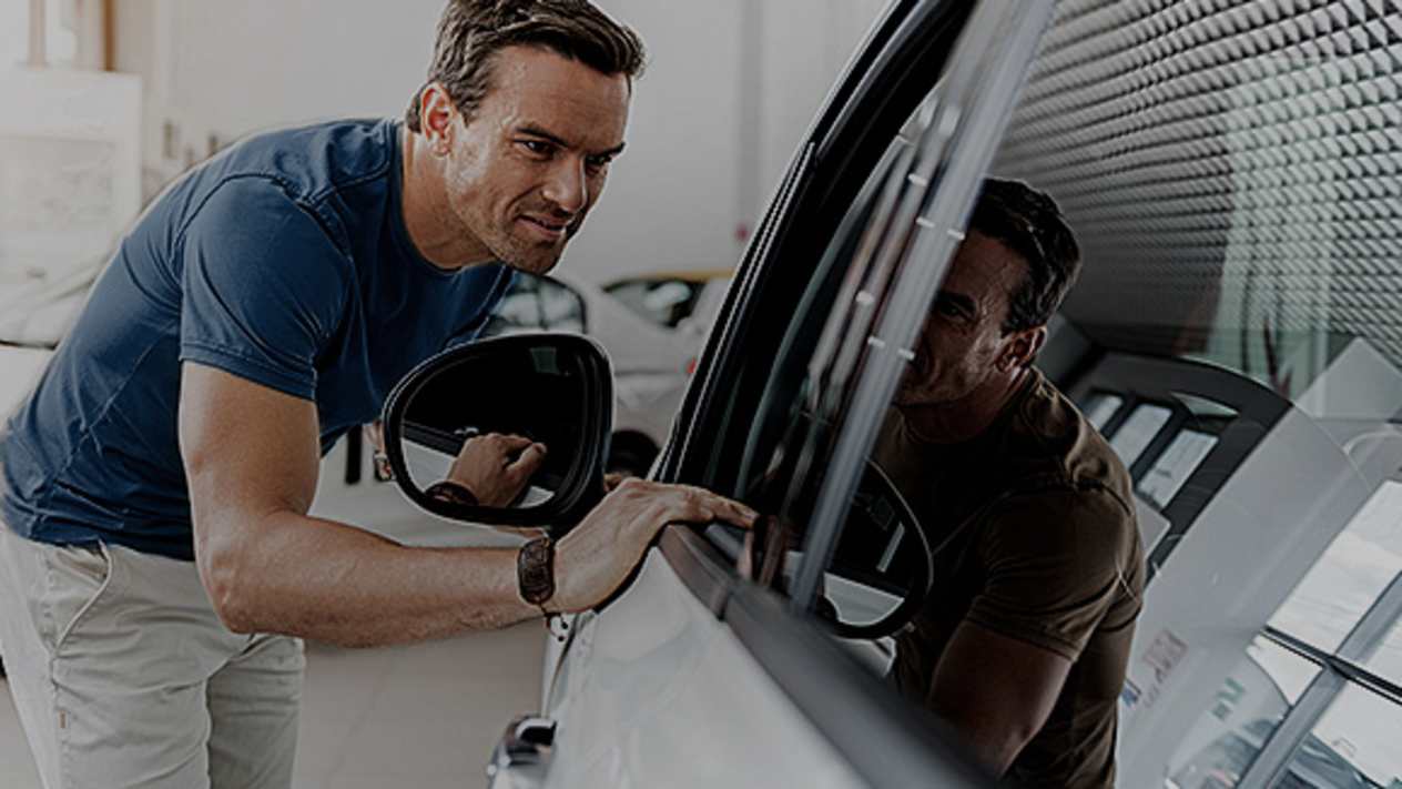 Man looking into car