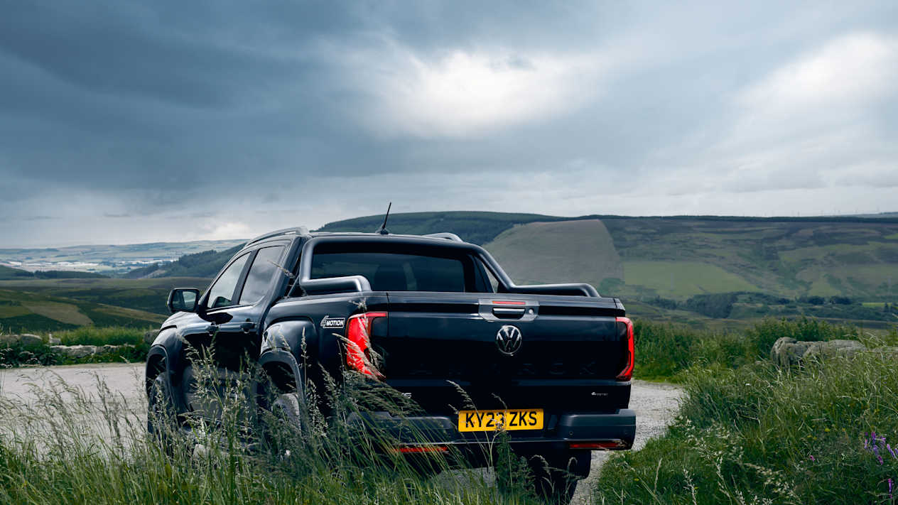 Rear view of the Black Volkswagen Amarok with the Scottish countryside in the background