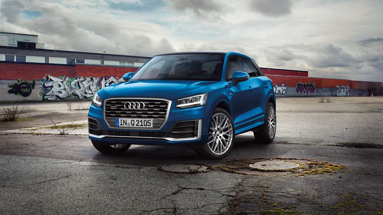Audi Q2 in Navarra Blue parked on wet concrete 