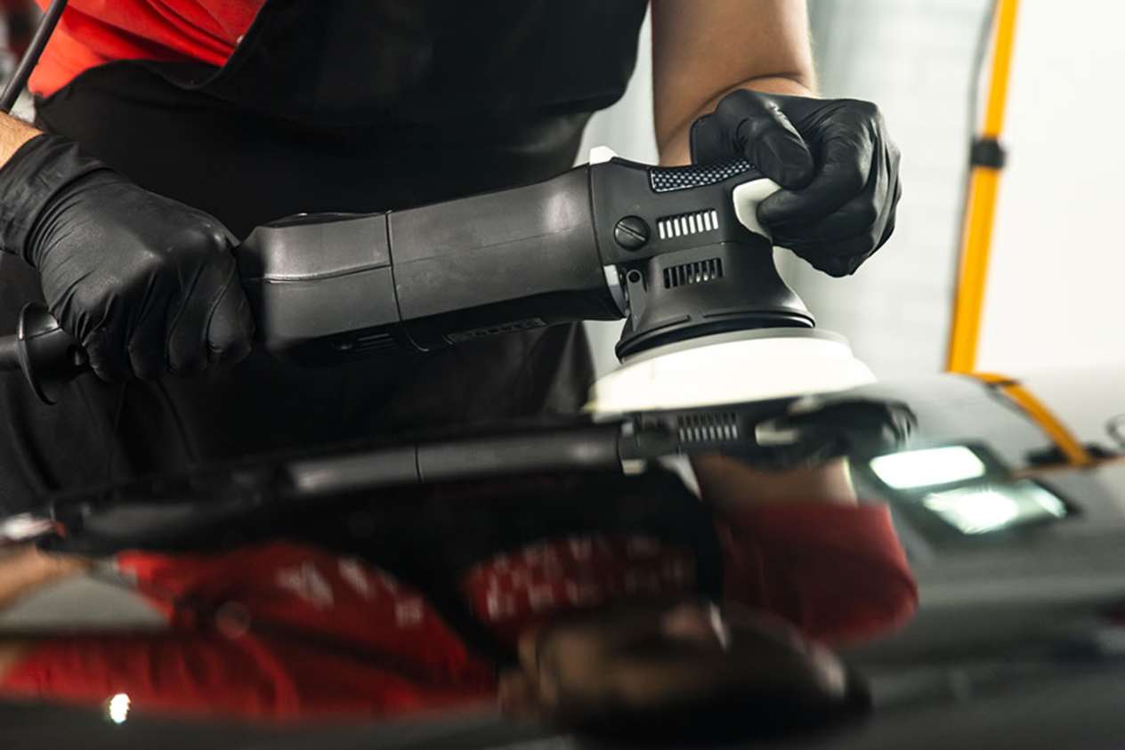 Audi mechanic polishing car 
