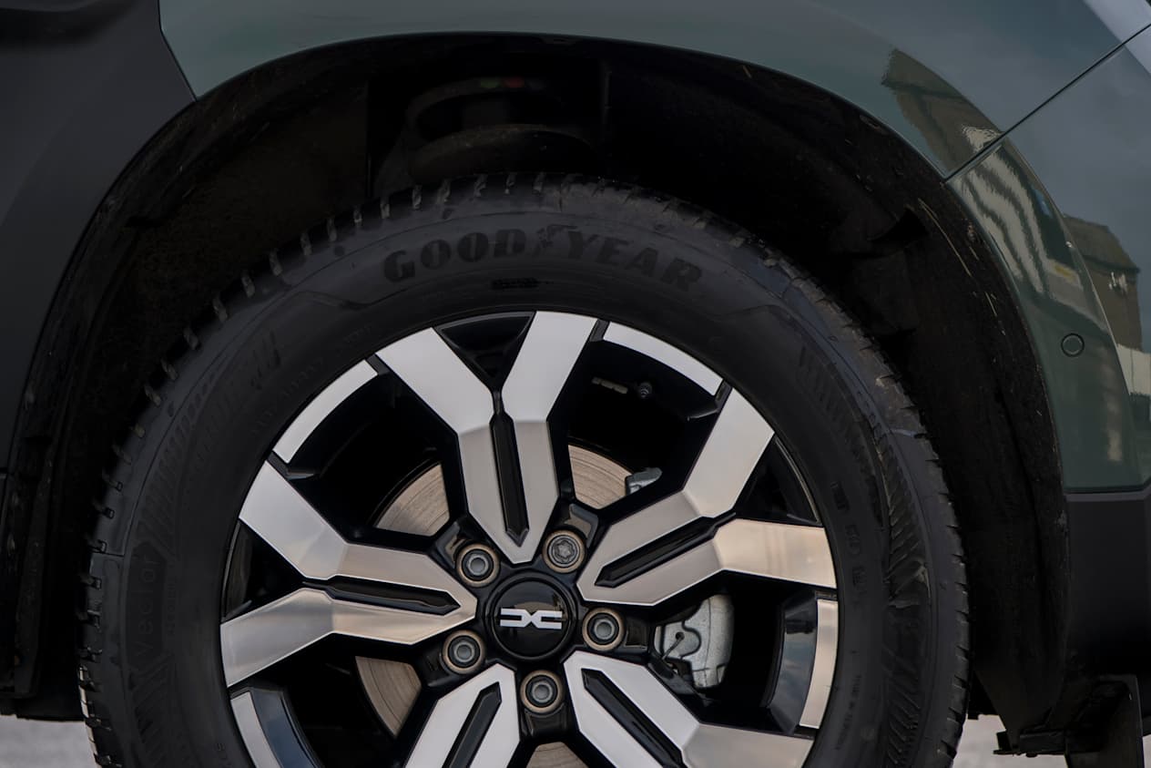 Close up of the front side of the Dacia Duster showing the tire, alloy, and wheel arch