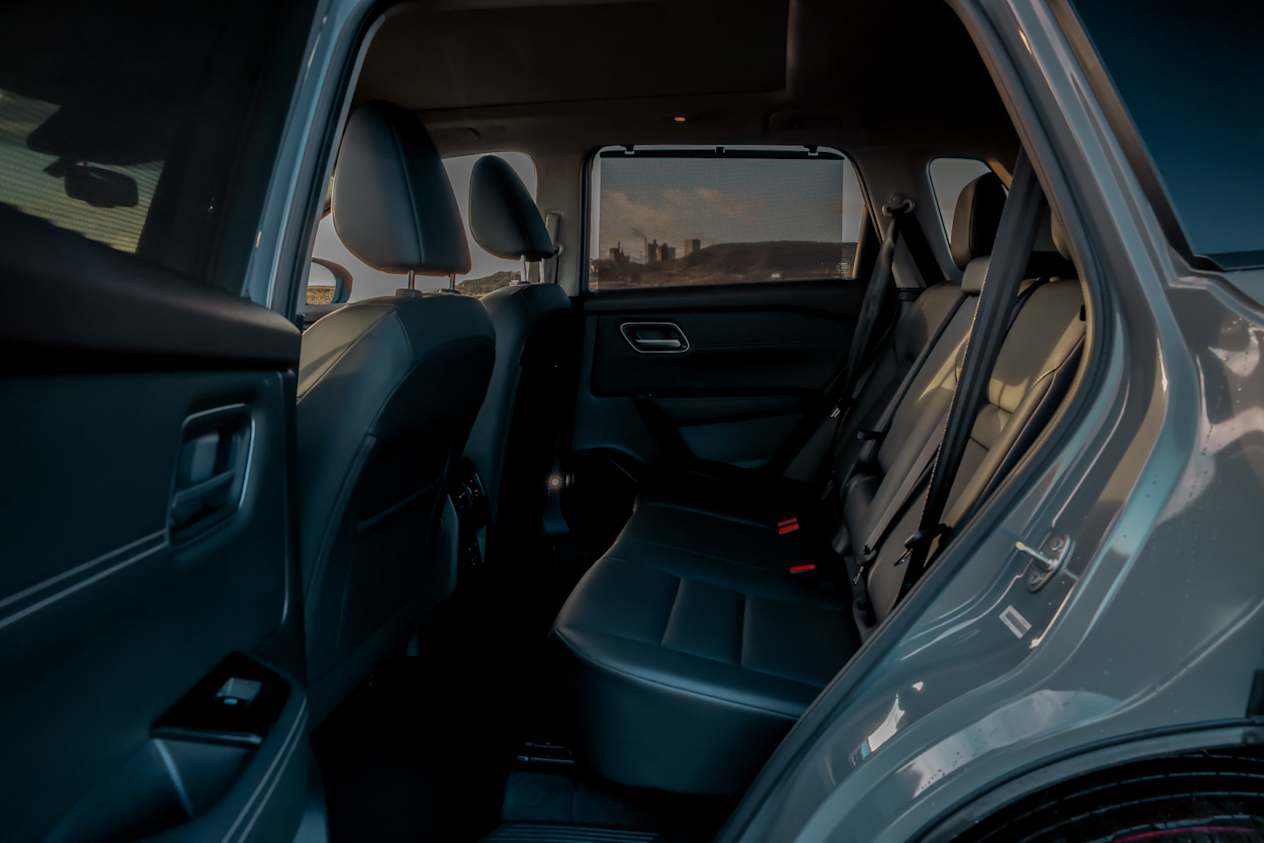 Looking across at the rear passenger space inside a grey Nissan X-Trail