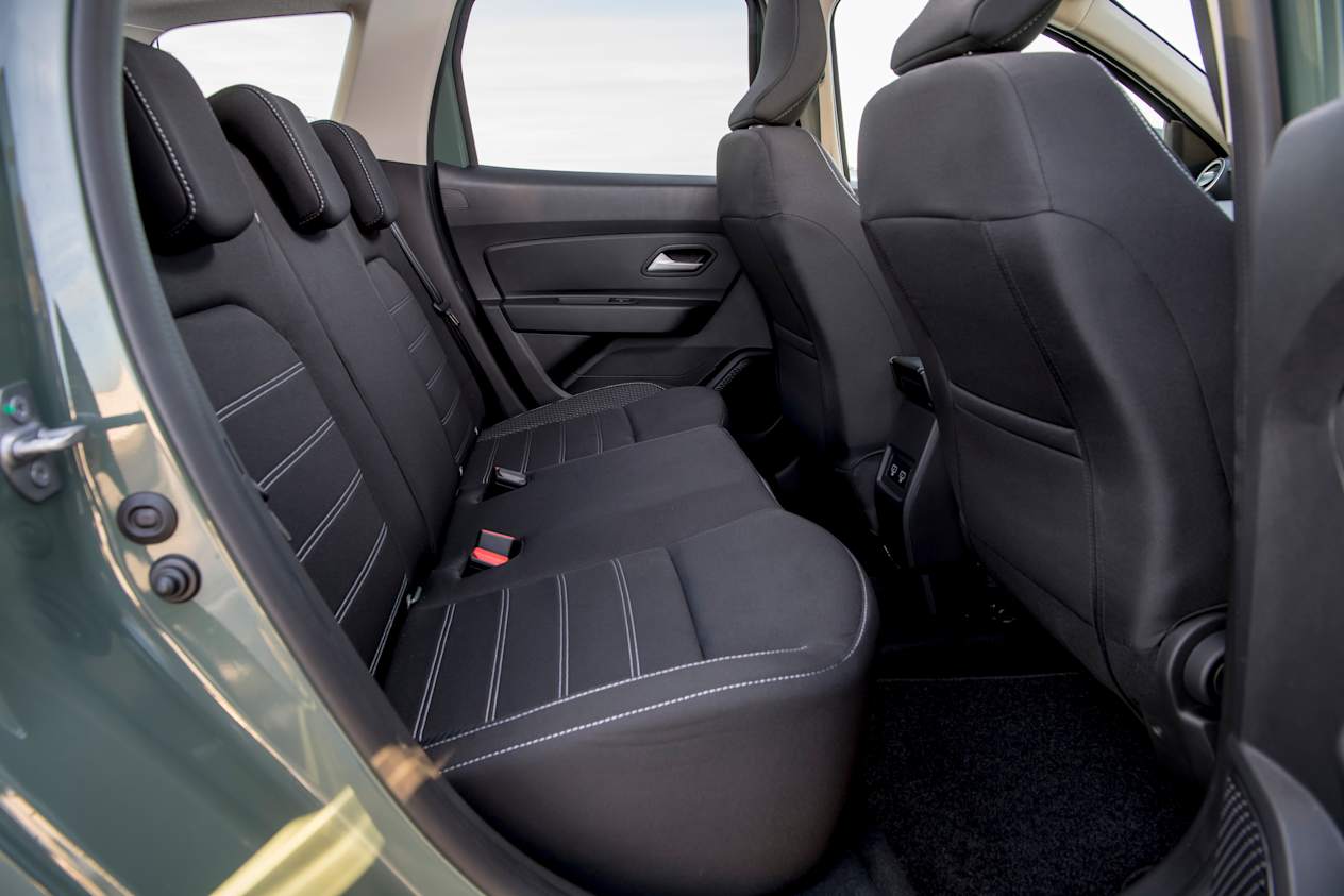 Interior view of the Dacia Duster showign the rear seats from the driver side