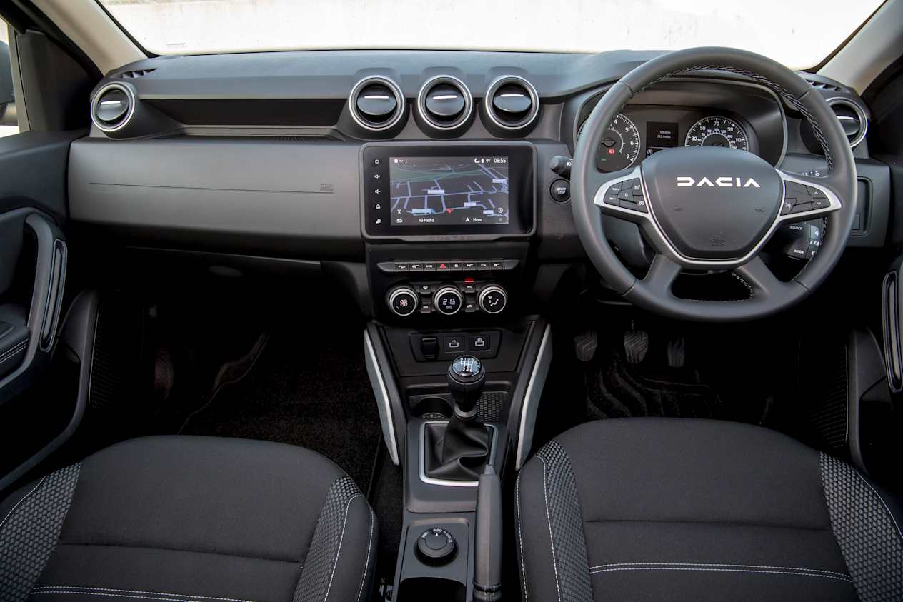 Interior view of the Dacia Duster showing all driving controls and screens in the front of the cabin