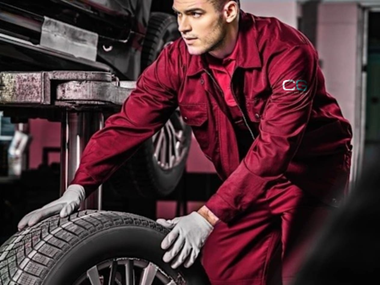 Croxdale Service Technician wearing red overalls with the new white and Green Croxdale Logo lettering