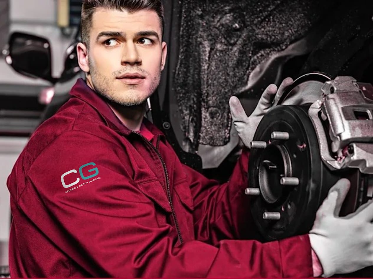 Croxdale Service Technician wearing red overalls with the new white and Green Croxdale Logo lettering