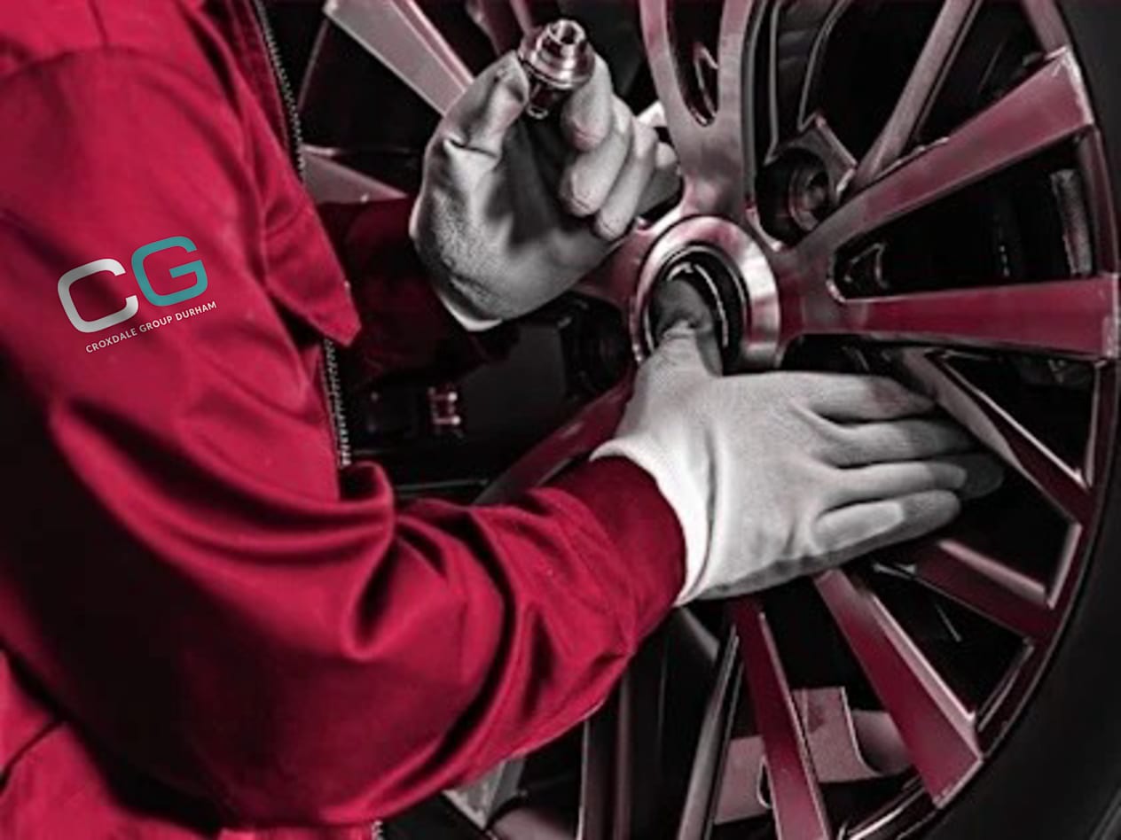Croxdale Service Technician wearing red overalls with the new white and Green Croxdale Logo lettering