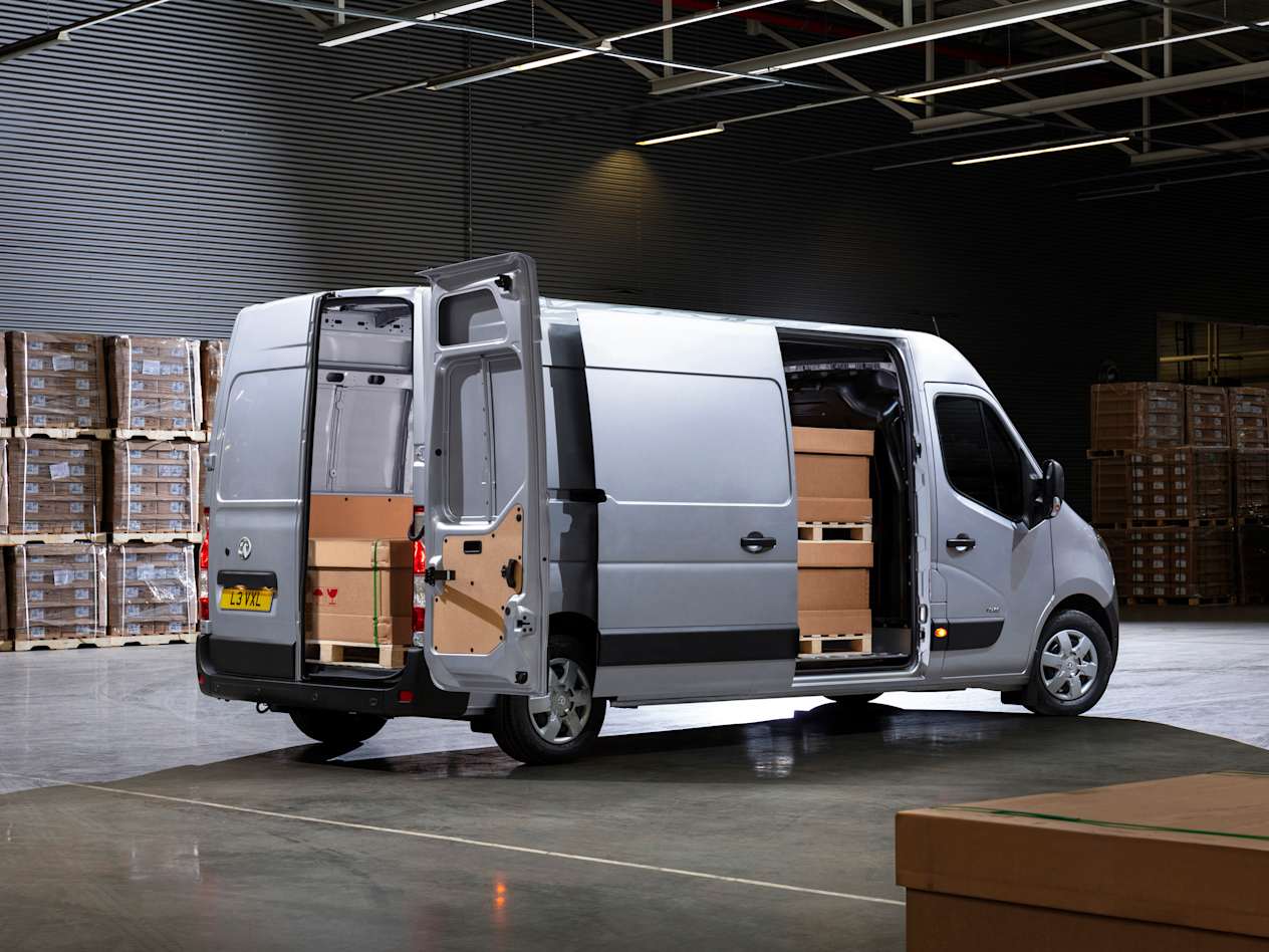 Rear and side view of a silver Vauxhall Movano showing the side and rear doors open and cargo inside
