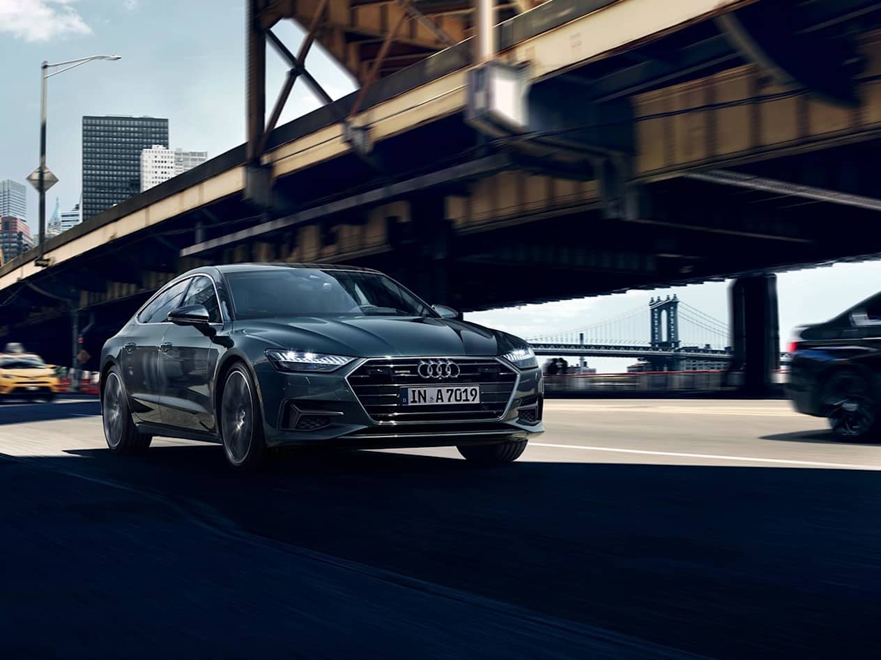 Audi A7 in Brilliant Black driving under bridge