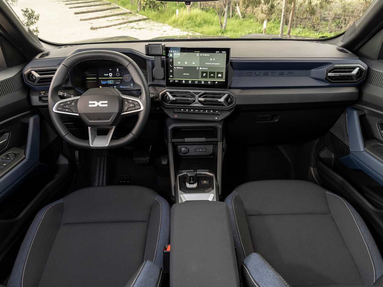 Looking over the front seats into the cabin of the All-New Dacia Duster showing all controls
