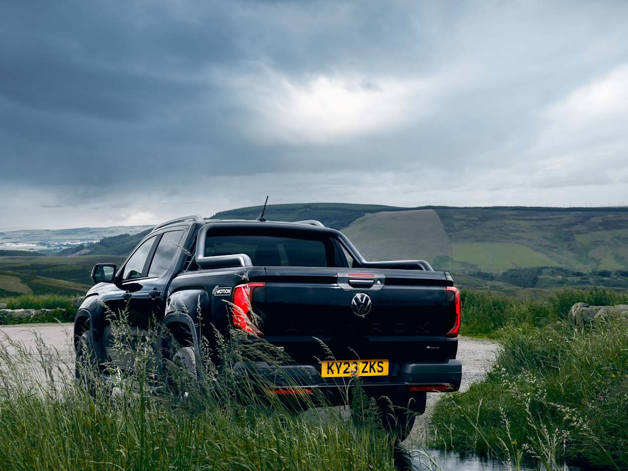 Rear view of the Black Volkswagen Amarok with the Scottish countryside in the background