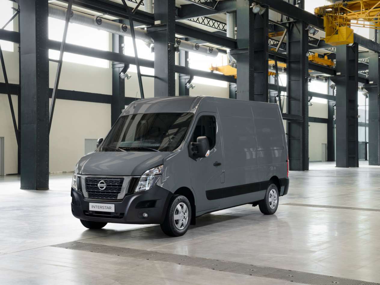 A grey Nissan Interstar sitting in an empty warehouse