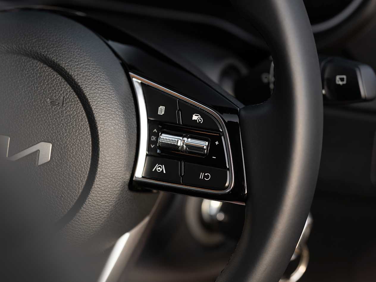 Close up of controls mounted on the steering wheel of the Kia Ceed