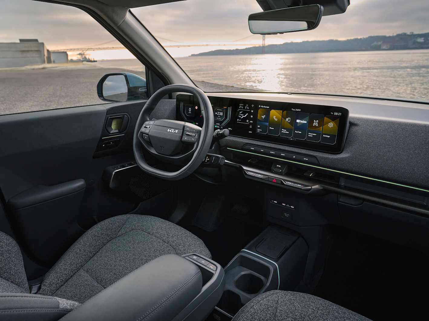 Kia EV2 charging port in use, showing the long-range 61kWh battery charging capability