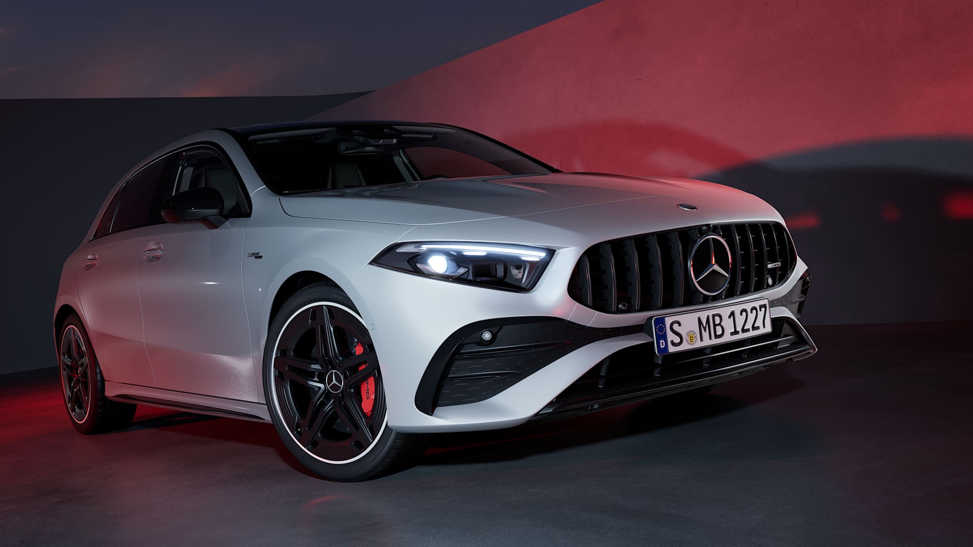 Grey Mercedes-AMG A 35 Hatchback front three-quarter view with laser light beams in a dark setting