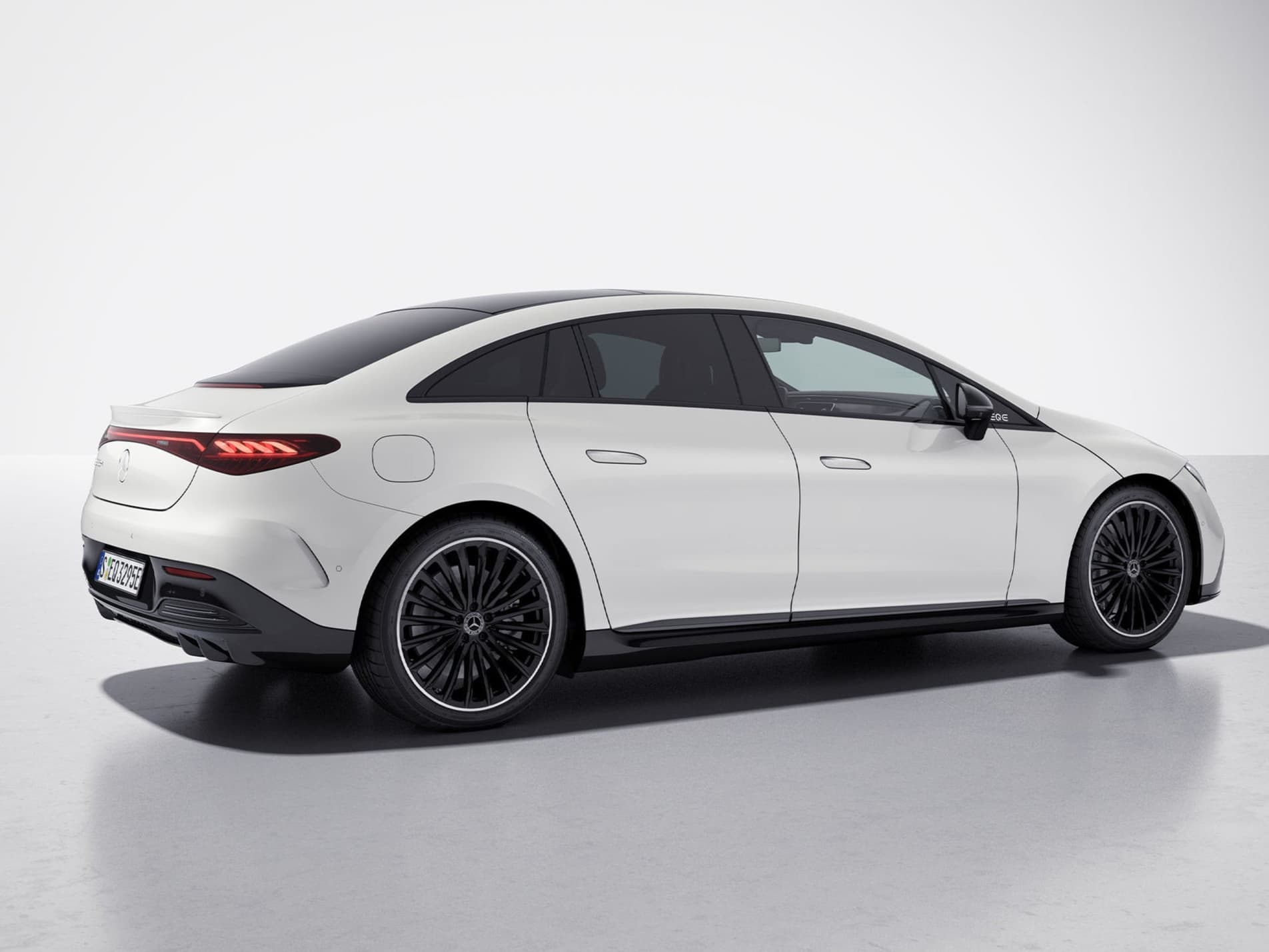White Mercedes-EQE with Night Package, from the rear three-quarter angle