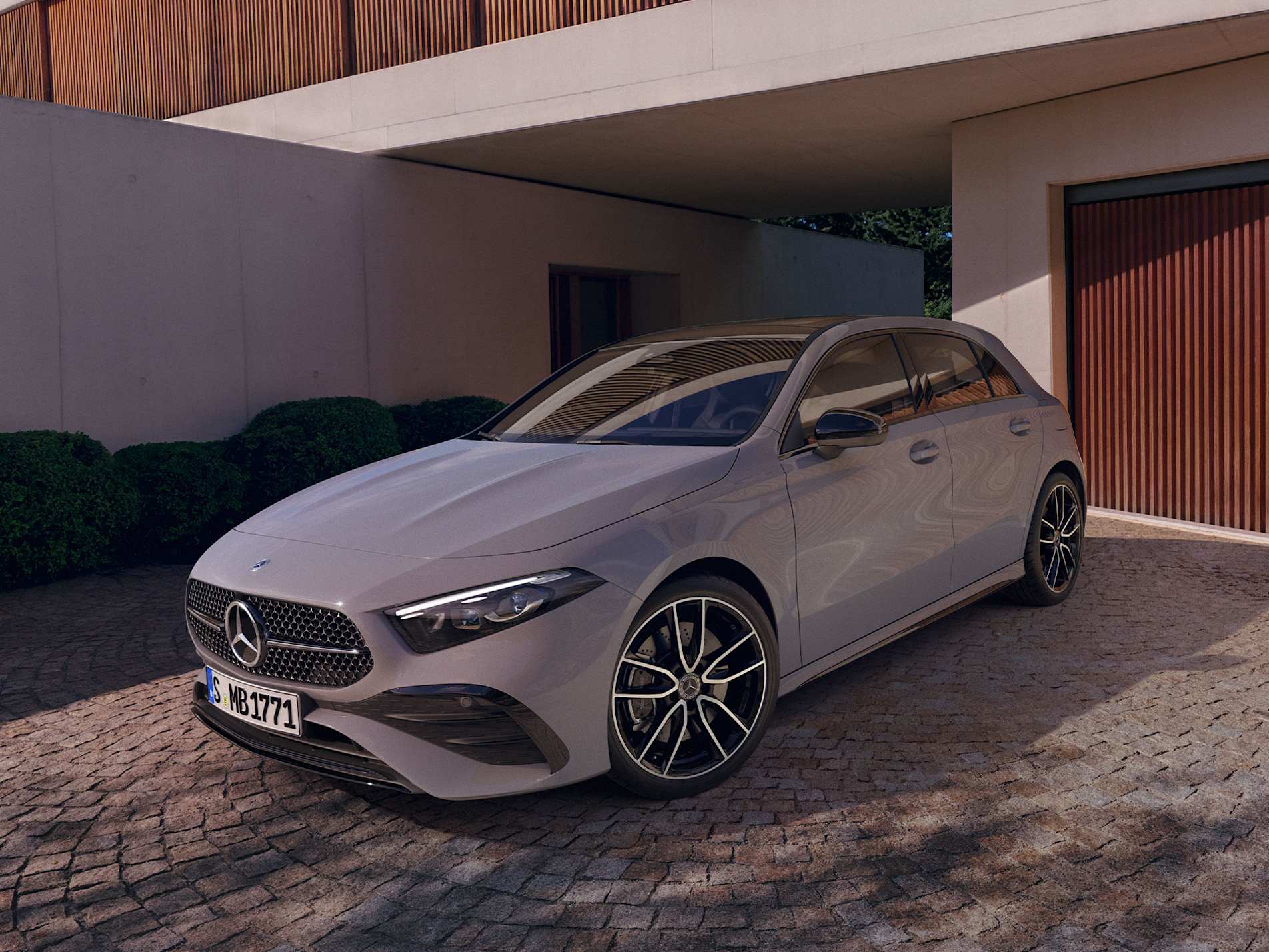White Mercedes-Benz A-Class hatchback parked outside a modern house