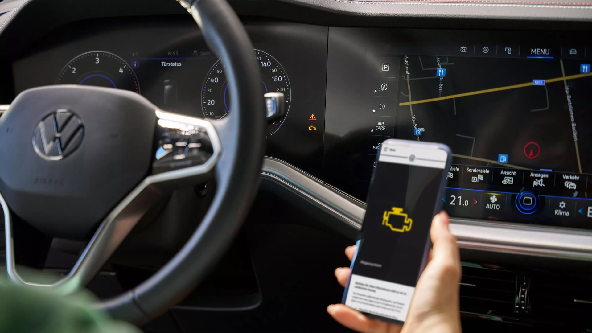 Driver checking a dashboard warning light on their phone – Volkswagen warning lights guide from Camerons Volkswagen, Perth